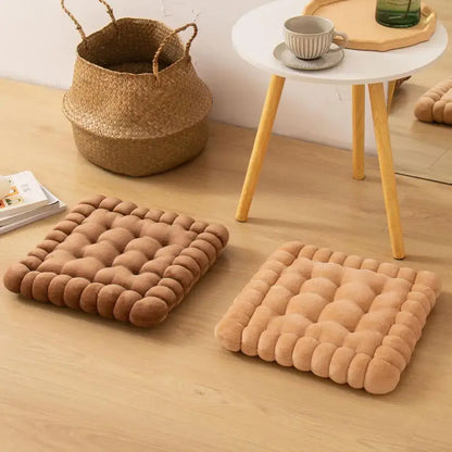 Two beige quilted cookie biscuit cushions with plush bubble texture on wooden floor for living room use