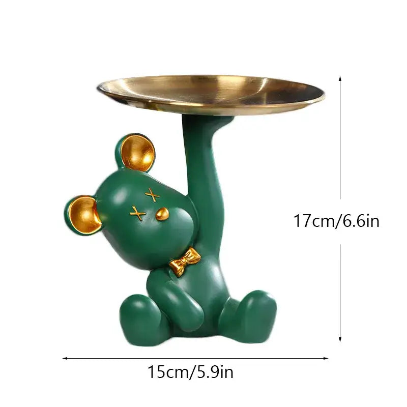 Green resin bear house entry tray keys receiver with gold accents holding brass tray for living room use