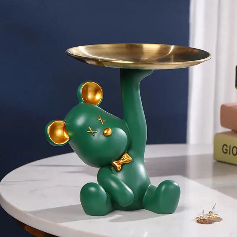 Green resin bear house entry tray keys receiver with gold accents holding a golden tray for living room use