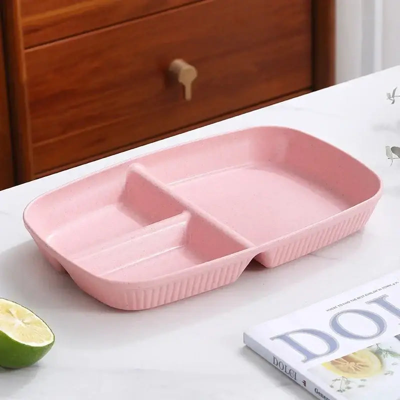Pink plastic divided dish diet plate with three ribbed edged compartments and utensils for dining room use