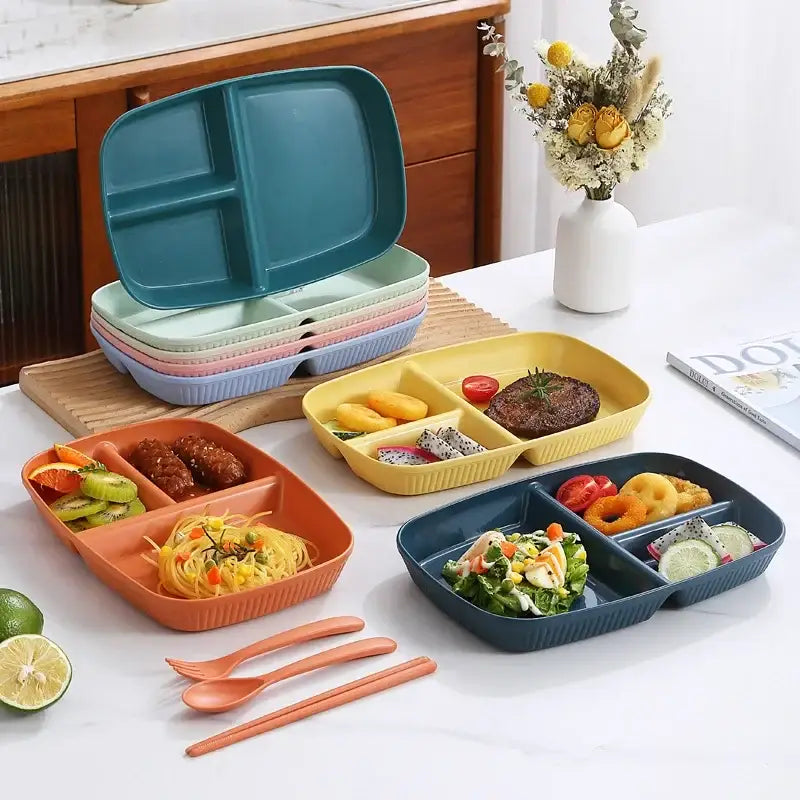 Set of colorful ribbed plastic divided dish diet plates in teal coral yellow and navy blue with orange utensils