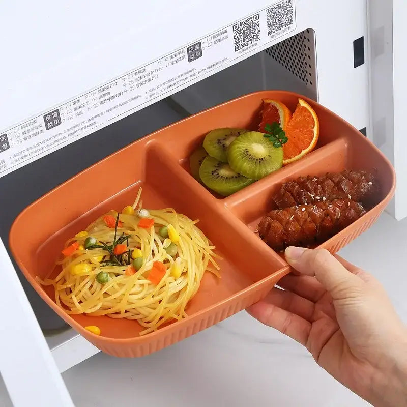 Orange plastic ribbed divided dish diet plate with three compartments and utensils for dining room use