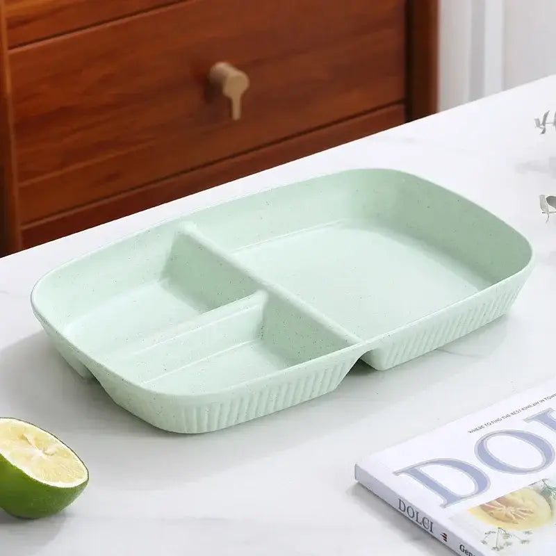 Light green rectangular plastic divided dish diet plate with three compartments and ribbed edges for dining room use