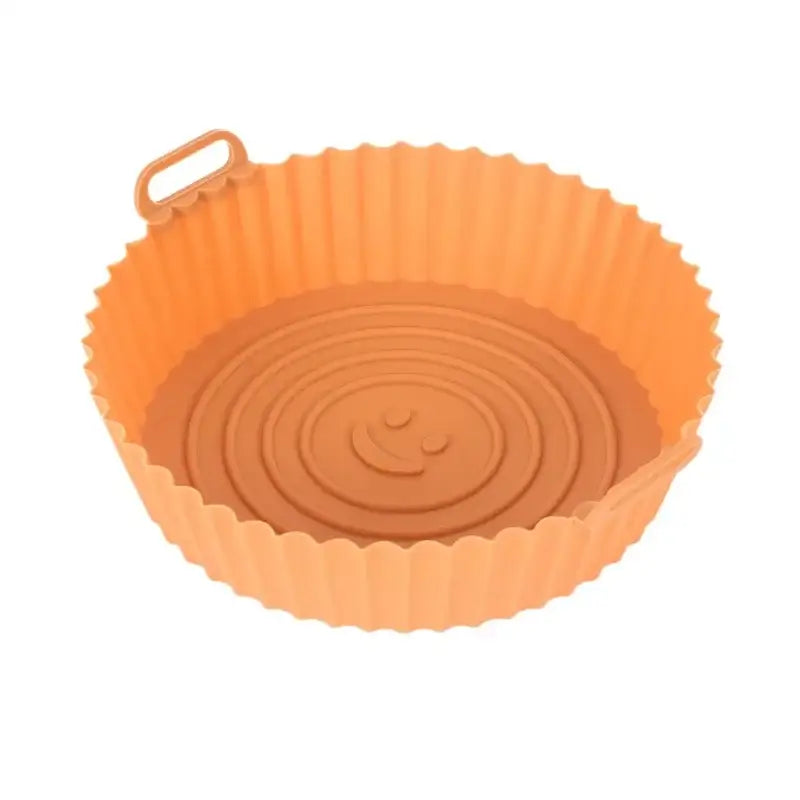 Orange silicone basket tray with scalloped edge and smiley face design for baking grill pan use