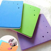 Colorful silicone foam cake shaping mat with evenly spaced holes for fondant embossing and decorative shaping use