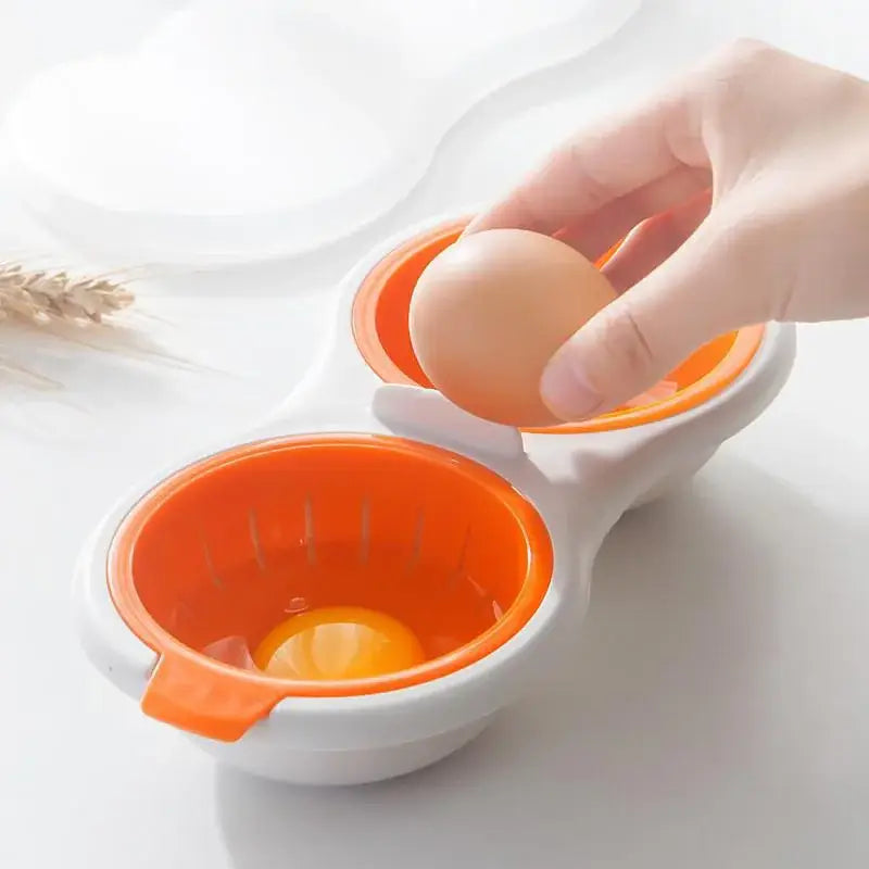 Orange and white silicone egg boiler with double compartments for separating yolk and egg white by hand cooking tools