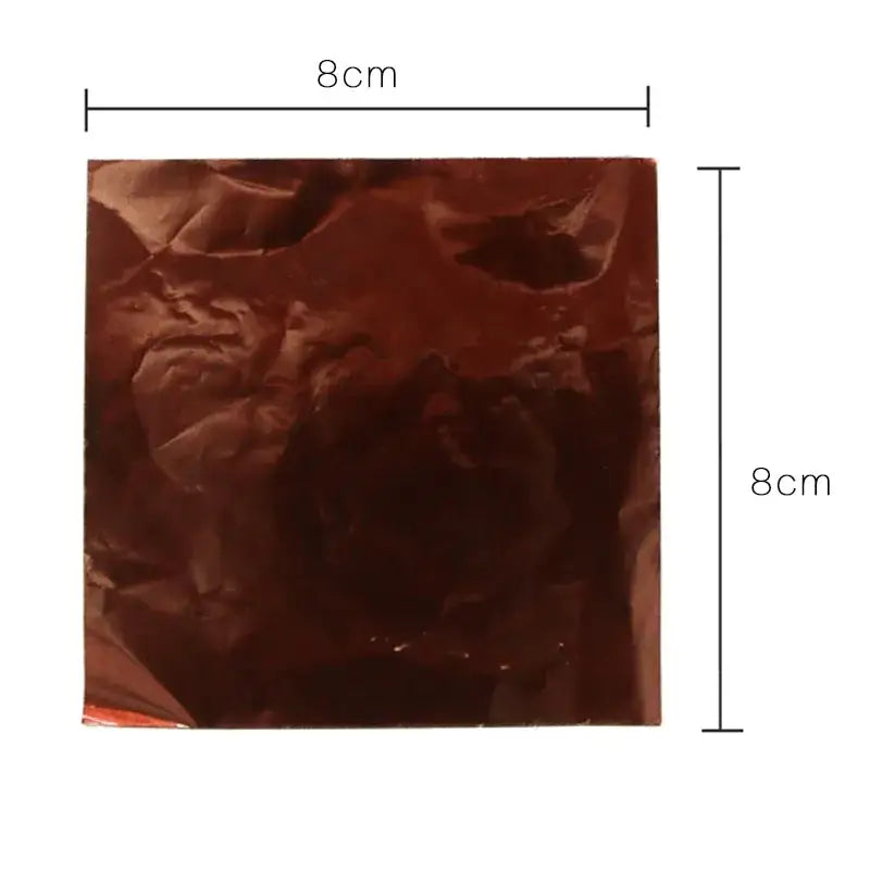 An 8x8cm square piece of crinkled copper-colored colorful tinfoils by decorbites for kitchen candy and chocolate wrapping