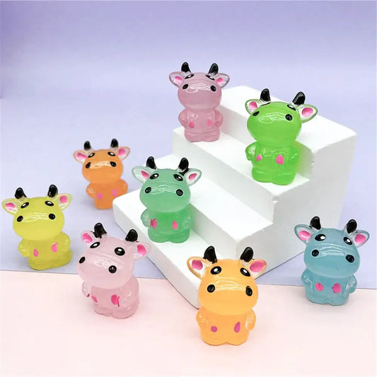 Colorful translucent plastic cow figurines with black horns and pink inner ears for fluorescence micro rabbit decor