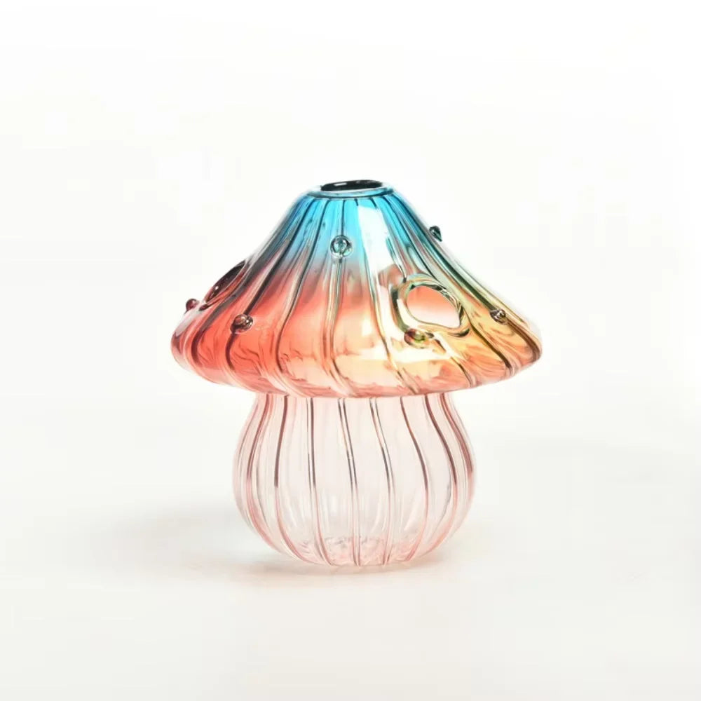A translucent glass mushroom vase with blue pink and orange hues and embedded gemstones for home decoration