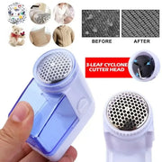 Compact blue and white electric fuzz pellet remover with translucent body and perforated metal cutting head for fabric care