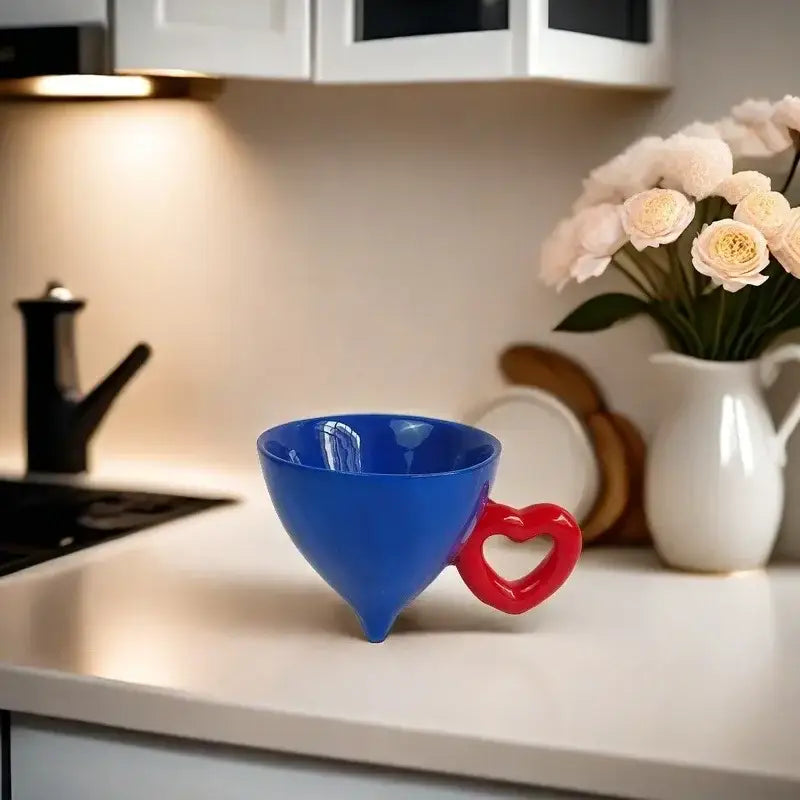 A vibrant blue conical cream heart ceramic coffee mug with a glossy finish and red heart ceramic handle for decorbites heart ceramic collection