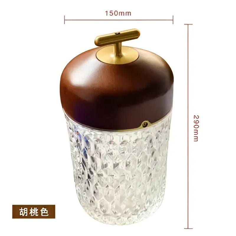 Brown wooden lid with brass handle atop clear faceted glass jar of decorbites conical crystal bedside lamp