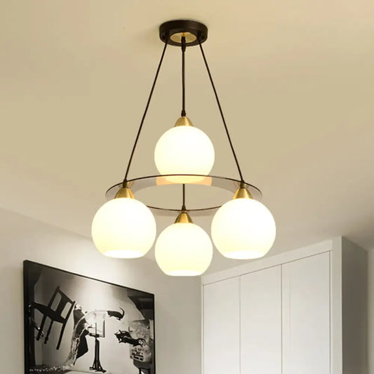 Lámpara de araña contemporánea de 4 luces en negro y dorado con pantalla de cristal opalino