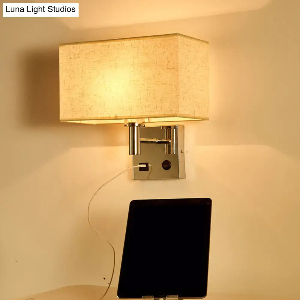 Contemporary beige fabric wall lamp with rectangular shade mounted on chrome fixture with integrated usb ports for bedroom use
