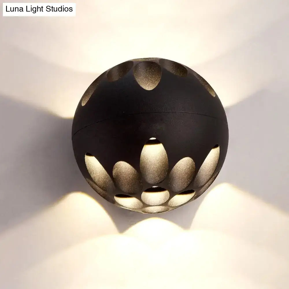 Contemporary black and gold spherical led wall lamp with lotus-inspired cutout design providing warm ambient wall light