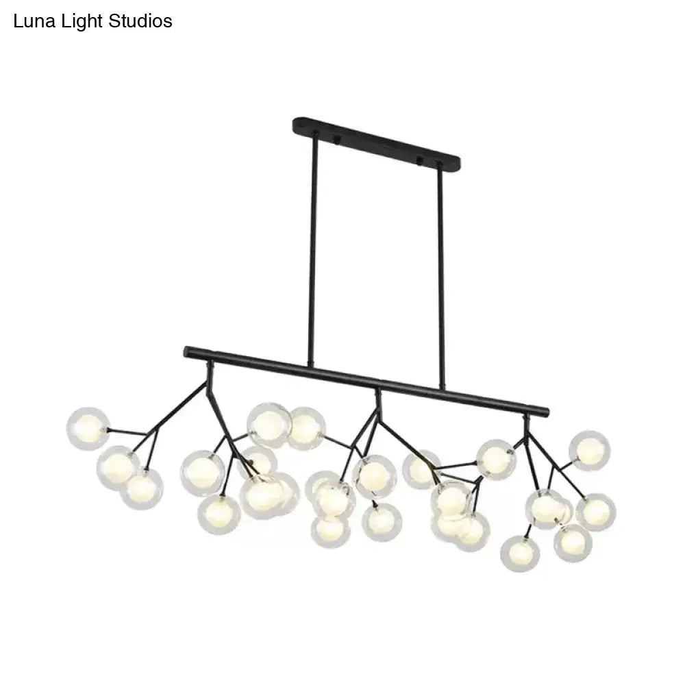 Black metal chandelier with frosted glass globe bulbs in a branching design for bubbles island lighting and island lighting