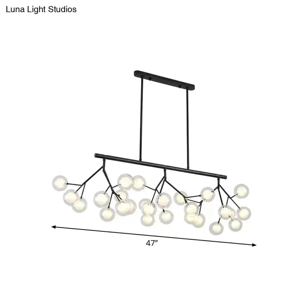 Black metal chandelier with frosted glass globe lights in a branching design for bubbles island lighting and island lighting