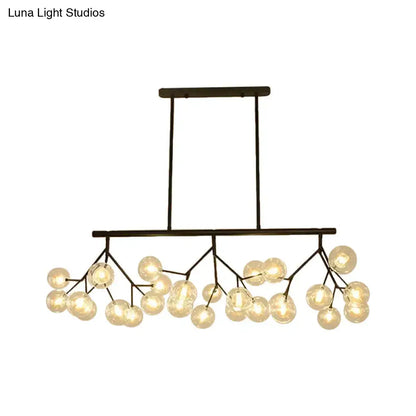 Modern black metal chandelier with frosted glass globe bulbs in a branching design for bubbles island lighting