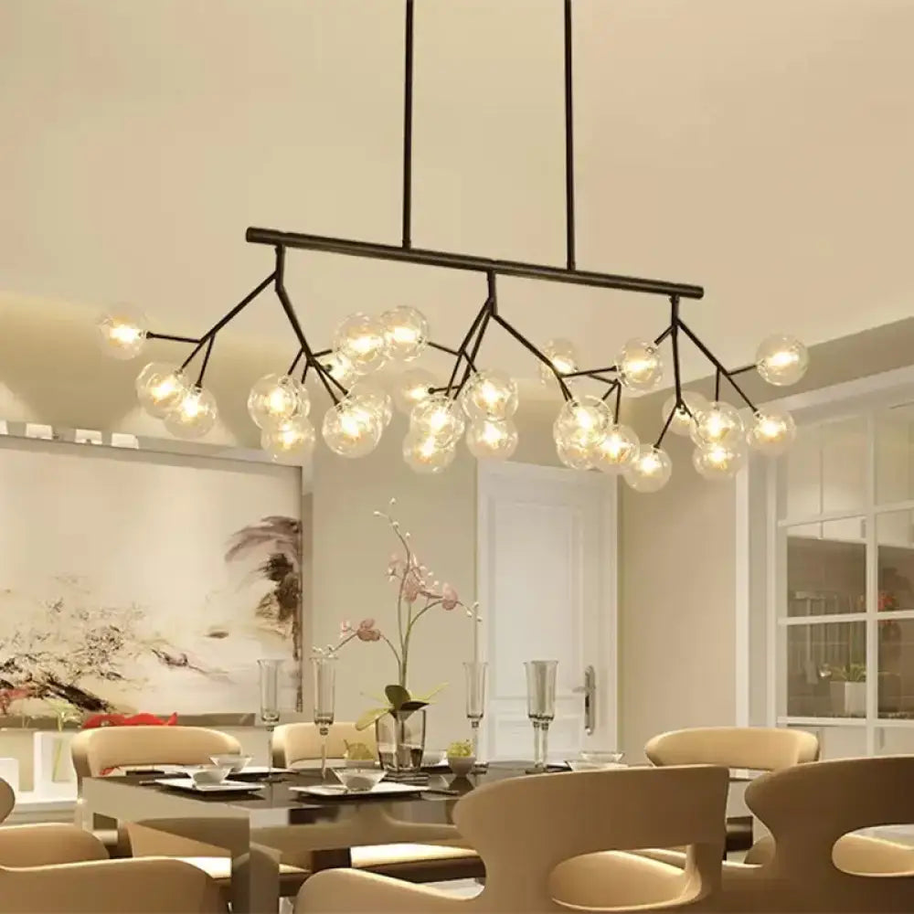 Modern black metal chandelier with black finish featuring 27 clear glass globe bulbs for bubbles island lighting