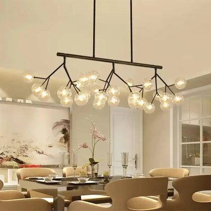 Modern black metal chandelier with black finish featuring 27 clear glass globe bulbs for bubbles island lighting