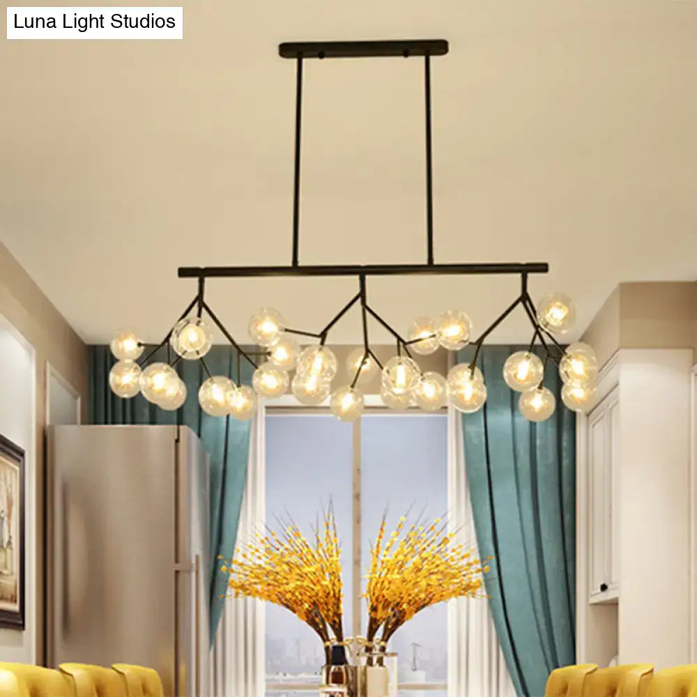 Modern black metal chandelier with multiple clear glass globe bulbs in black finish for bubbles island lighting