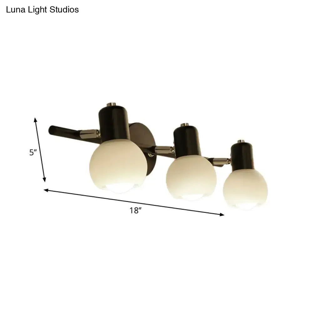 Contemporary black and chrome three-light vanity fixture with milk glass frosted globes for living room lighting