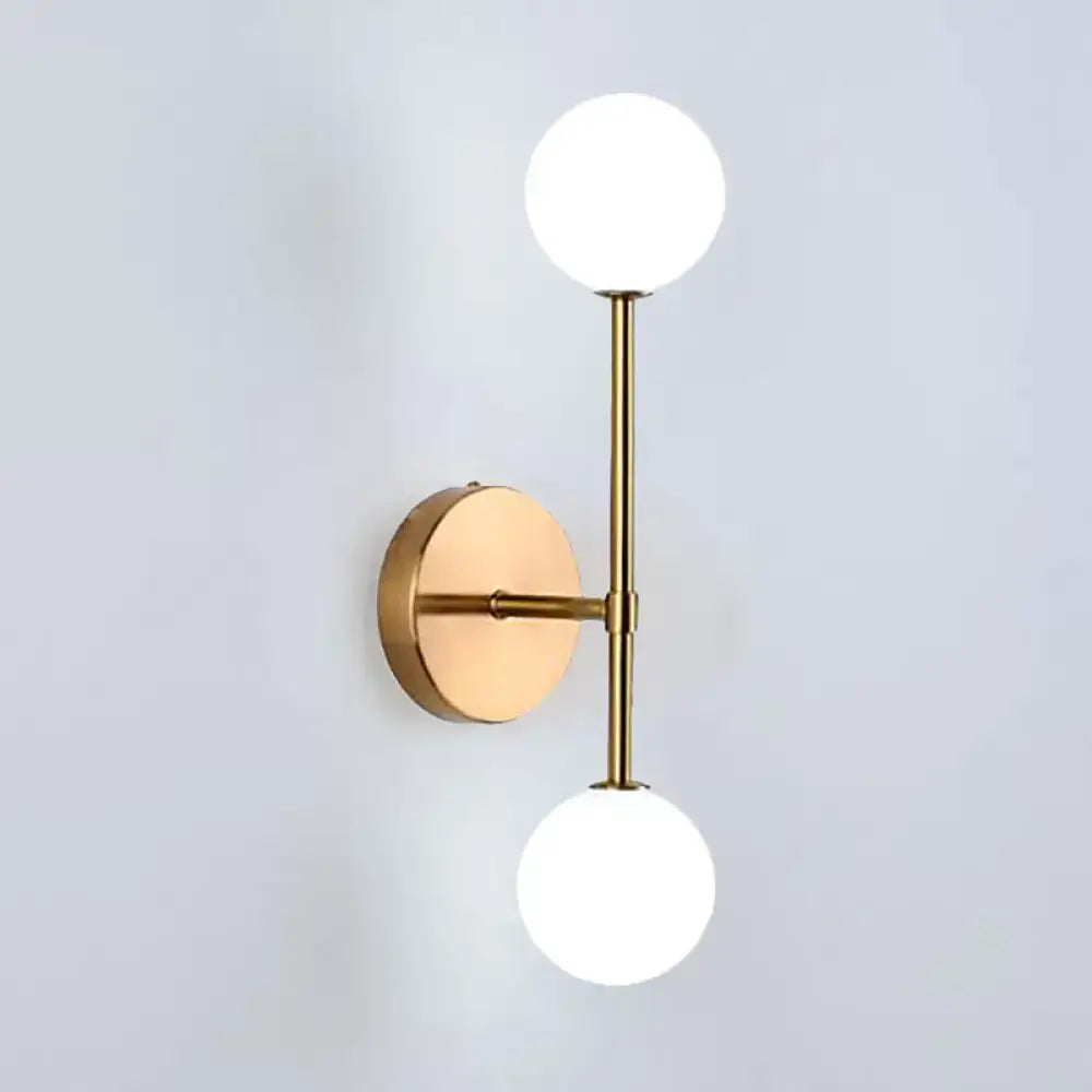 Contemporary black and gold wall lamp with modern brass dual ball design and two frosted glass globe shades inch fixture