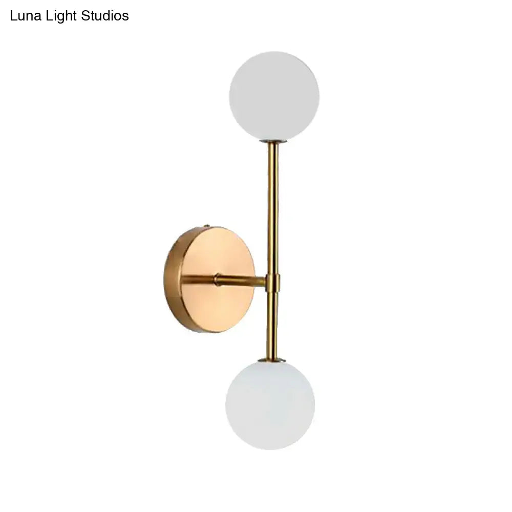 Contemporary black and gold wall lamp with modern brass finish and dual frosted glass globe shades inch fixture