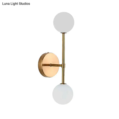 Contemporary black and gold wall lamp with modern brass finish and dual frosted glass globe shades inch fixture