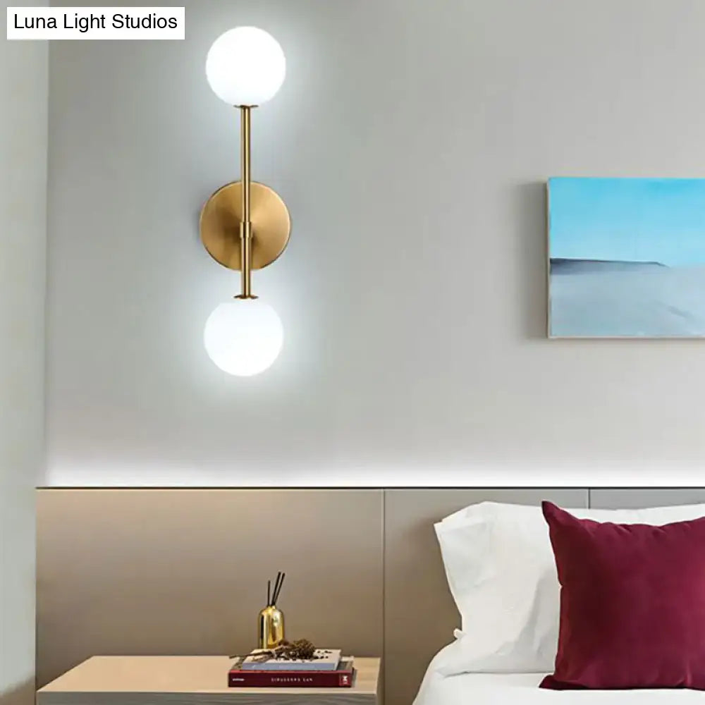Contemporary black and gold wall lamp inch fixture with dual frosted glass globes for bedroom lighting