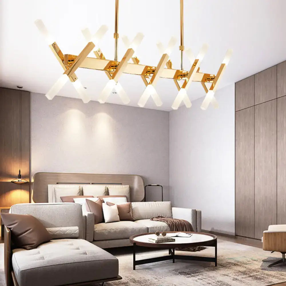 Gold-toned modern decorbites island pendant light with intersecting geometric arms and frosted glass shades for living room