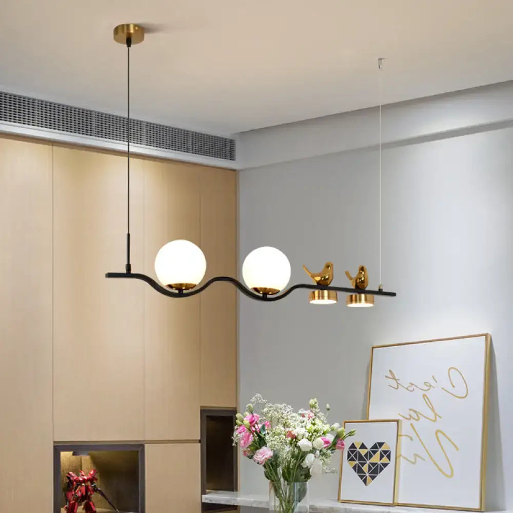 Modern black metal pendant light with cream glass balls and gold bird decor for branch dining room island lighting