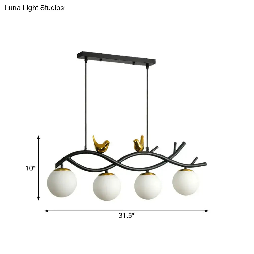 Decorbites™ black metal linear branch dining chandelier with gold bird accents and four cream glass ball shades