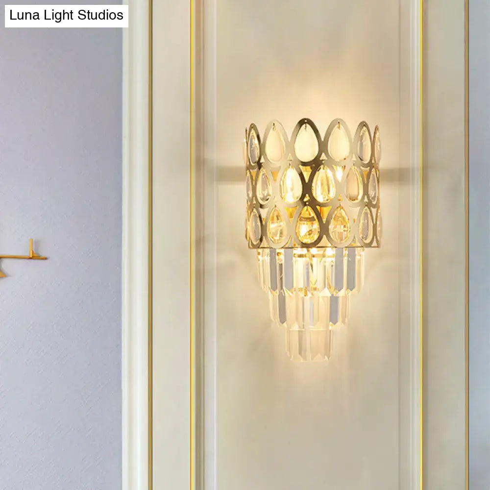 Contemporary black gold sconce with cascading teardrop crystal elements and grid wall mount for living room lighting