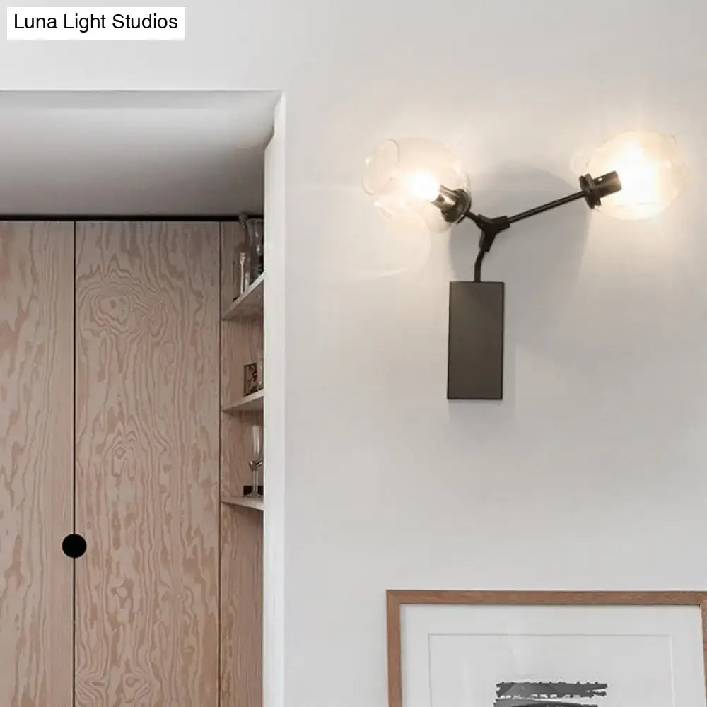 Contemporary black metal wall sconce with two frosted glass globe shades and clear glass shade for wall light