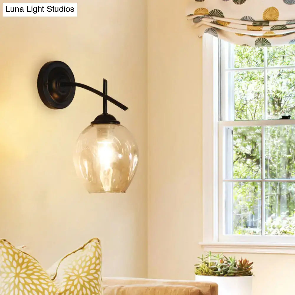 Contemporary black wrought iron wall sconce with clear glass shade and amber globe for bedroom light wall decor