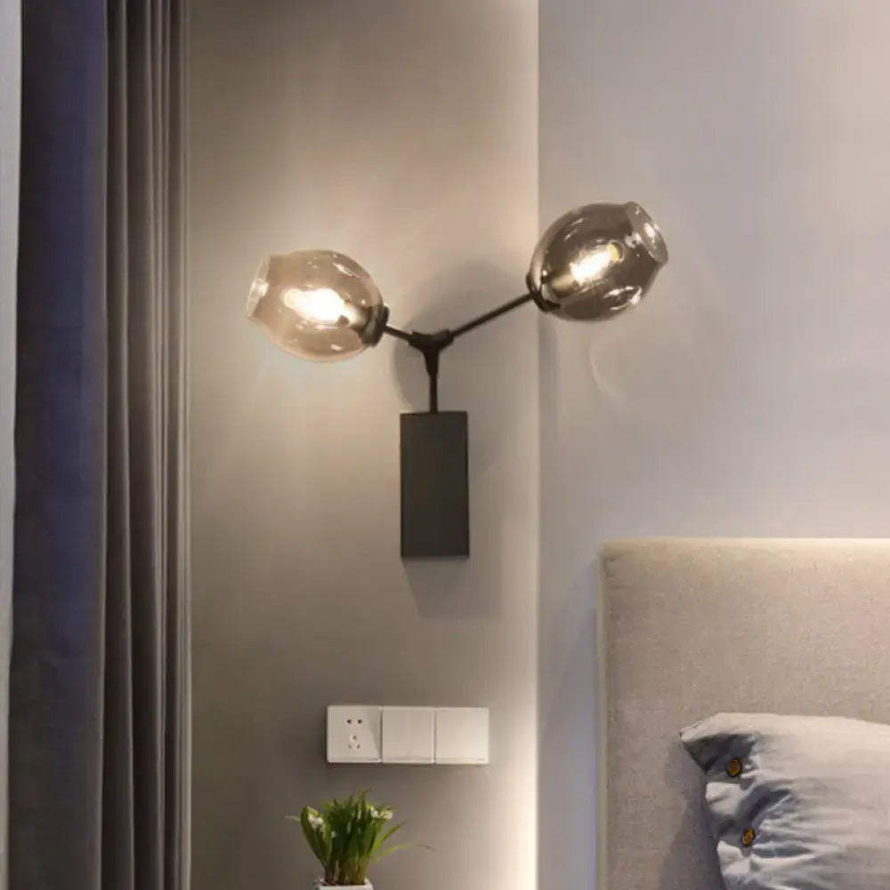 Contemporary black and gold two-arm wall sconce with clear glass shade and sleek metal base for light wall use