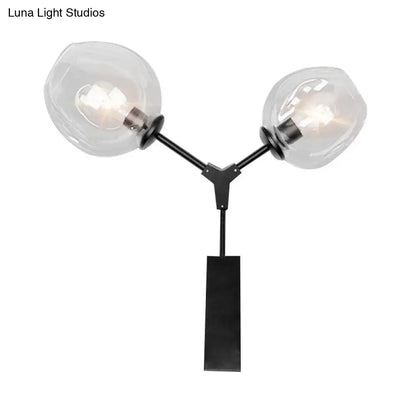 Contemporary black metal wall sconce with two clear glass shade globes for elegant bedroom light wall decor