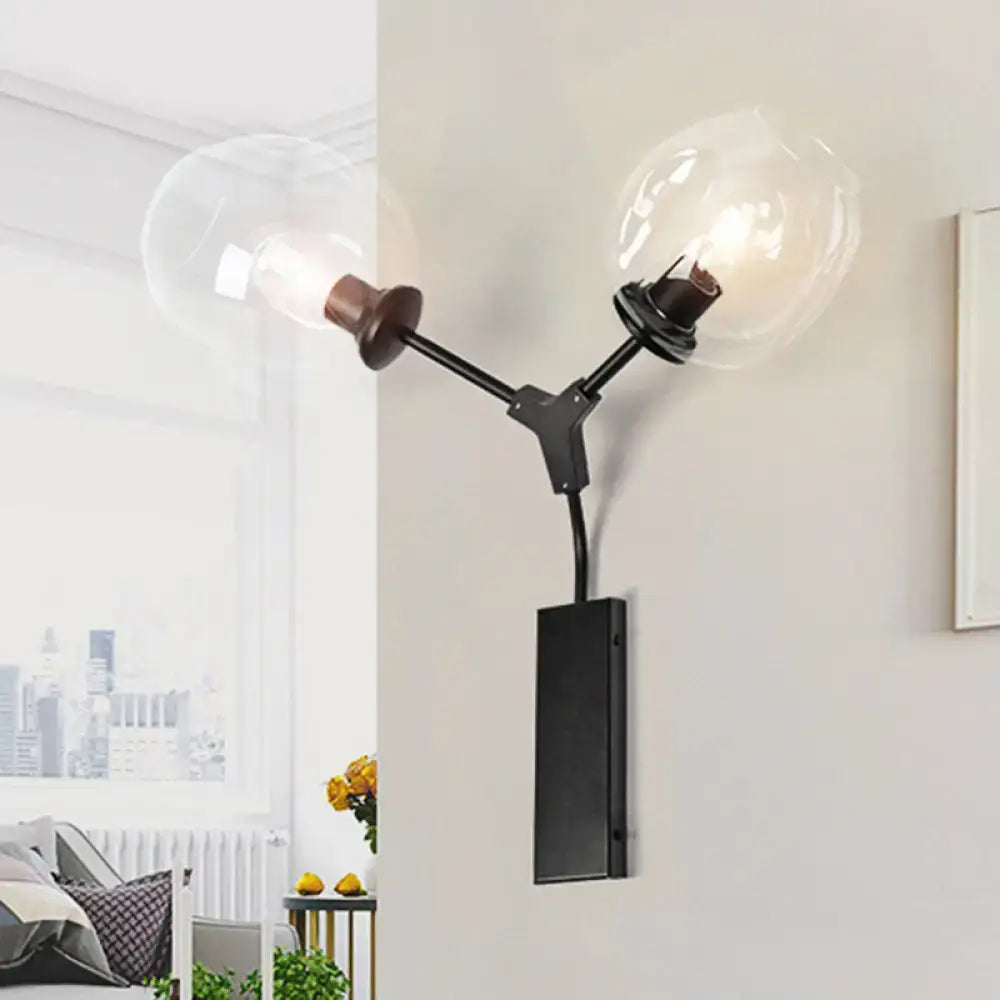 Contemporary black metal wall sconce with clear glass shade and two globe bulbs for bedroom light wall mounting
