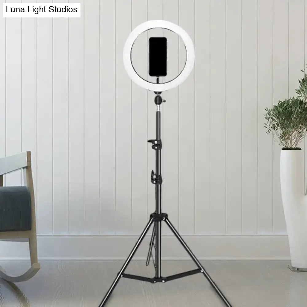 Contemporary black metal ring flash lamp with usb port and bulb included mounted on a tripod stand for bedroom use