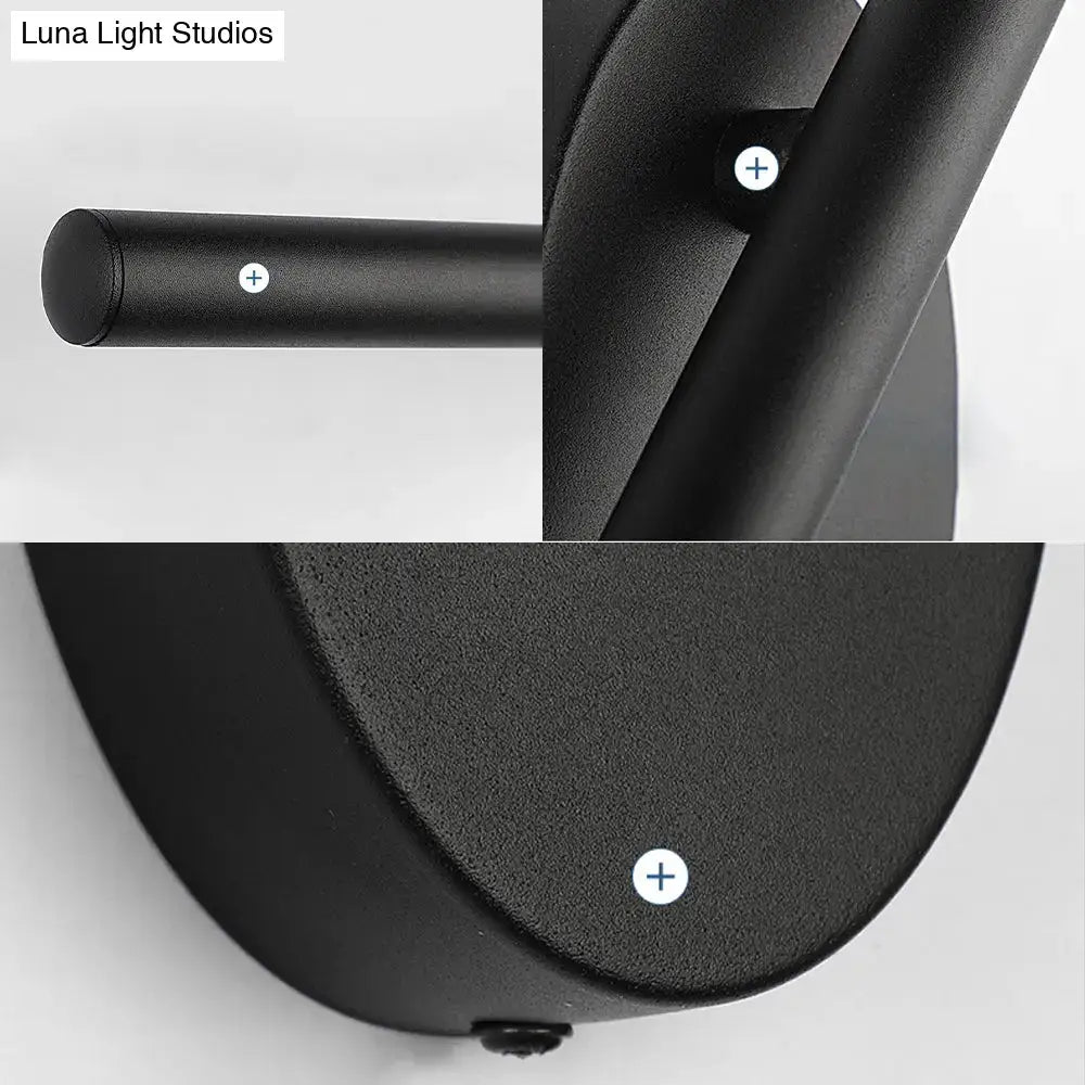 Contemporary black slim wall light with matte finish and cylindrical stem designed for bedroom natural light use