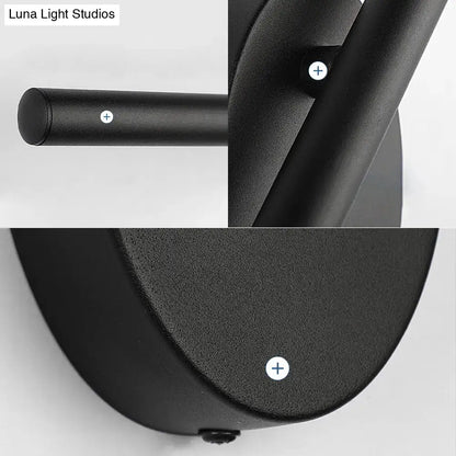 Contemporary black slim wall light with matte finish and cylindrical stem designed for bedroom natural light use