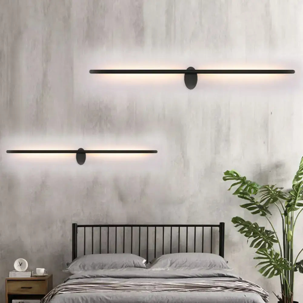 Contemporary black slim wall light featuring modern oval mounting plates and sleek bars for natural light use