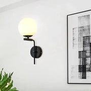 Contemporary black metal wall mount lighting with frosted glass globe shade for bedroom use