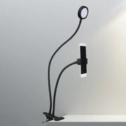 Contemporary black flexible led desk lamp with phone clamp and circular led light head for bedroom use