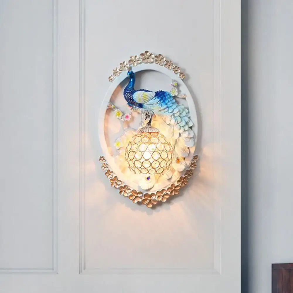 Contemporary blue and white peacock wall sconce with gold floral accents and crystal ball for living room living space