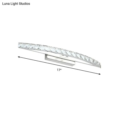 Contemporary silver bow shaped wall sconce with clear faceted crystals for vanity lighting in bathroom