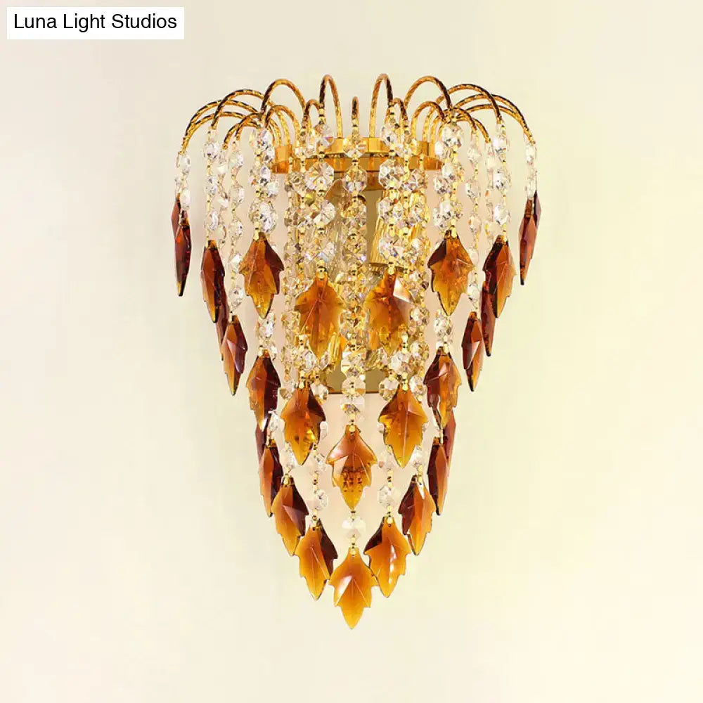 Contemporary brass wall light featuring a golden leaf-shaped crystal sconce with amber and clear glass accents for extra light