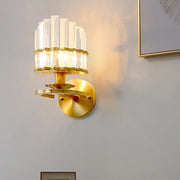 Contemporary brass wall lamp with gold-toned circular plate and clear crystal vertical prisms for e12 e14 bulbs