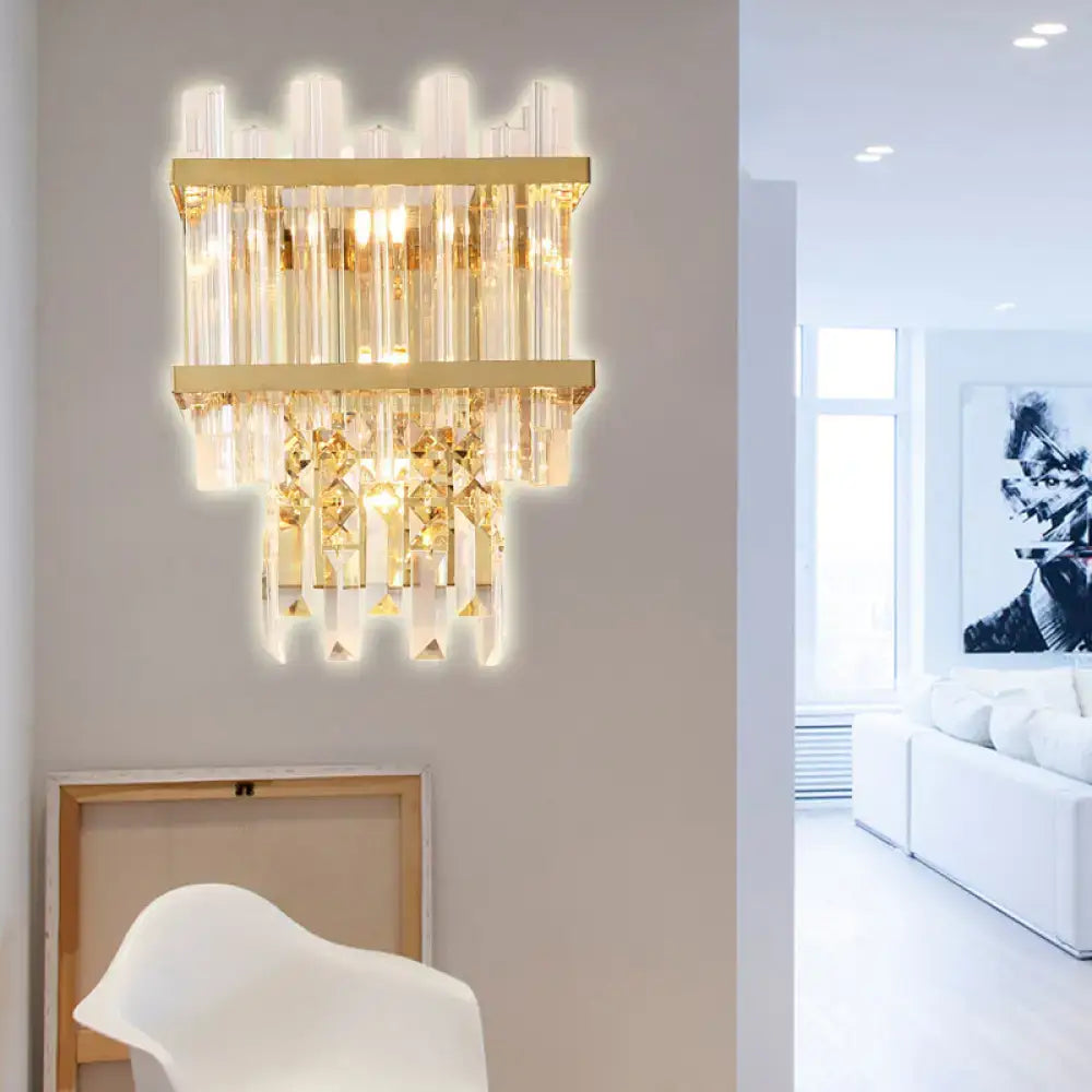 Contemporary brass chrome wall lamp with gold-toned sconce, cascading clear glass tubes, and faceted crystal accents